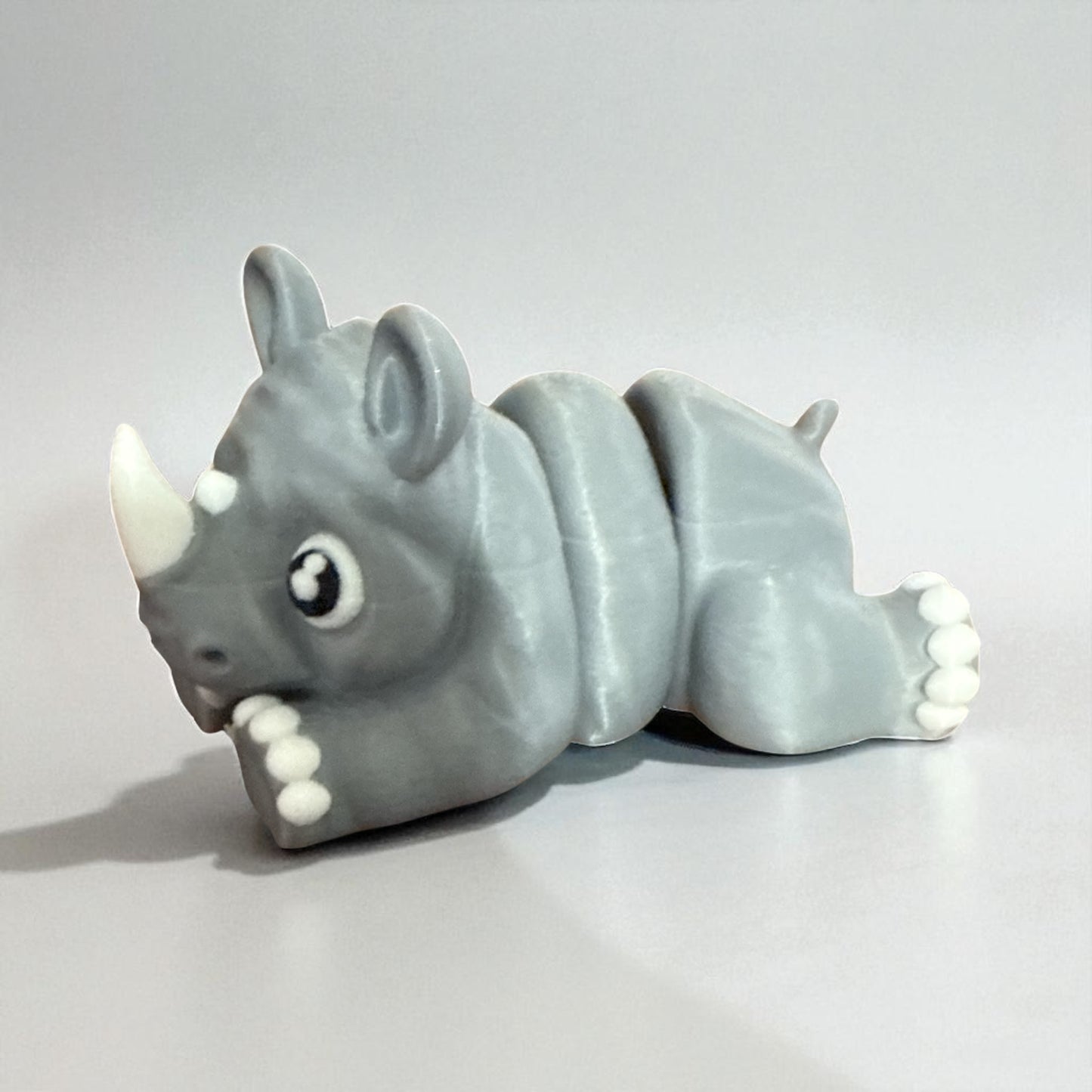 Cute Baby Rhino Articulated Figurine Adorable Wildlife Companion with Big Eyes and White Paws Perfect for Kids Room Decor