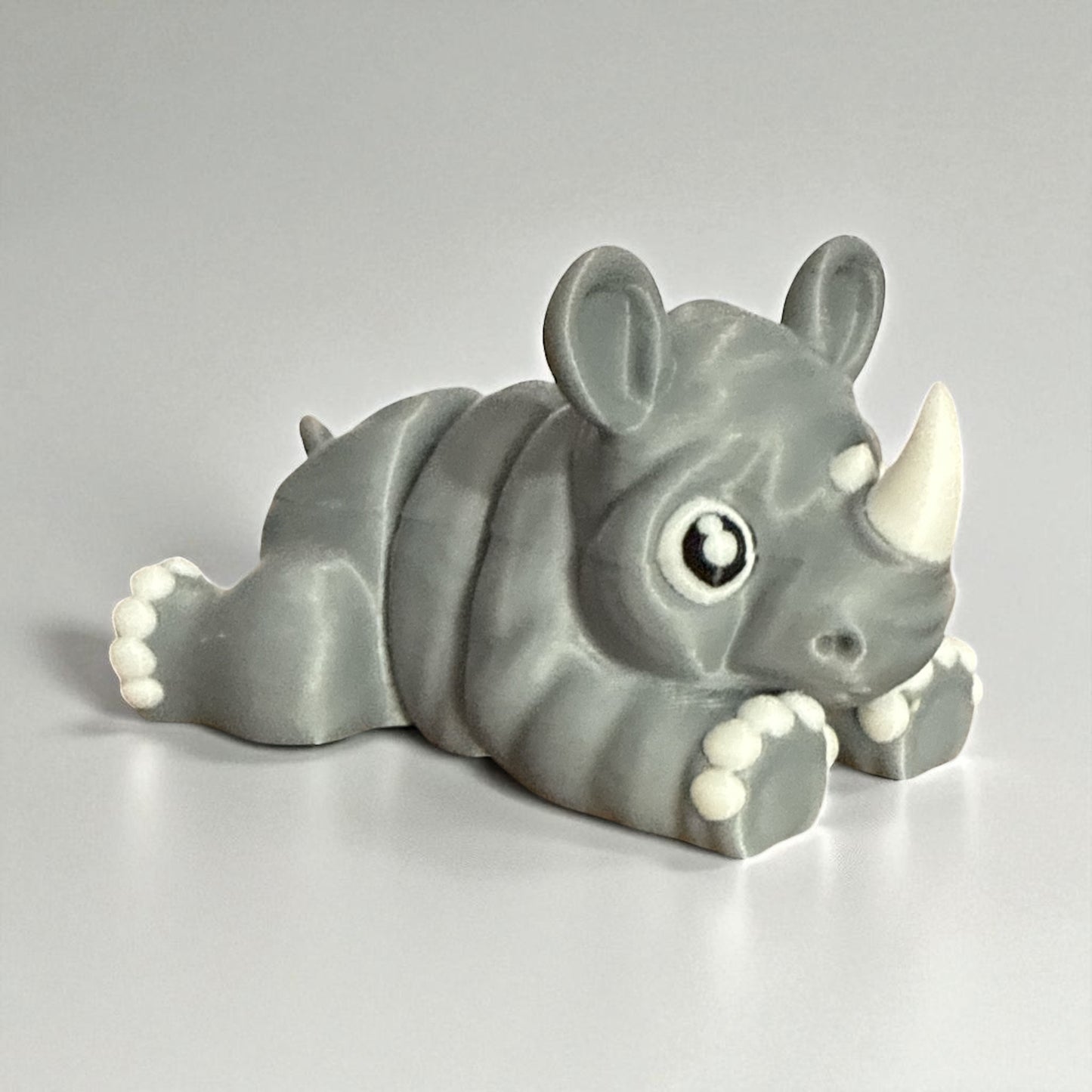 Cute Baby Rhino Articulated Figurine Adorable Wildlife Companion with Big Eyes and White Paws Perfect for Kids Room Decor